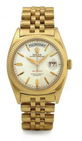 Day-Date, Ref 6511, First Generation.Rolex, Oyster Perpetual, Day-Date, Officially Certified Chronometer, Ref. 6511. Made in 1956..Very rare and fine, early, tonneau-shaped, center-seconds, selfwinding, water-resistant, 18K yellow gold wristwatch.with day