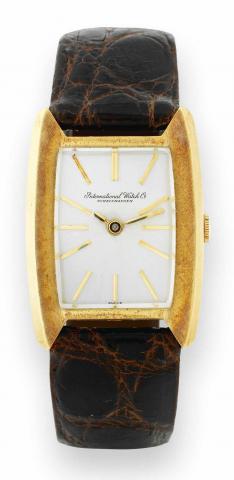 Ref. 1311 Yellow Gold.International Watch Co., Schaffhausen, No..1288790, case No. 1687770, Ref. 1311. Made in the 1970's..Fine and rare, tonneau-shaped, 18K yellow gold wristwatch.with an 18K yellow gold buckle. Accompanied by a fitted.box.