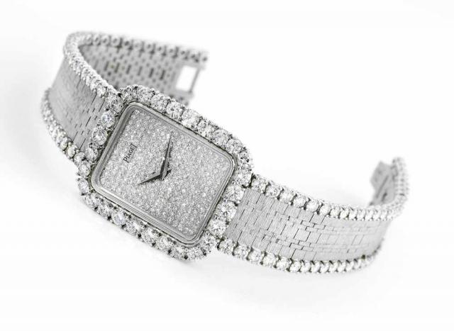 White Gold and Diamonds.Piaget, case No. 488218, Ref. 92976. Made circa 2000..Fine and unusual, 18K white gold and diamond-set rectangular wristwatch with pave-set diamond dial and an integral 18K white.gold Piaget textured brick link bracelet, edges set 