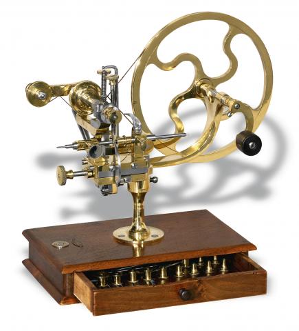 Rounding-Up Tool.Retailed by Sandoz Fils Co., La Chaux-de- Fonds.Bienne, No. 5367, Swiss. Made in the late 19th century..Fine, brass and steel rounding-up tool on wooden base with.selection of cutting wheels.