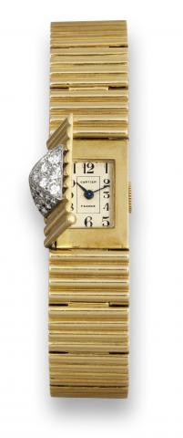 Cartier Duo-Plan.Cartier, France, Duo-Plan, case No..360, Ref. No. 3713. Made in the 1950's..Fine, rare and unusual 18K yellow gold.diamond- set lady's wristwatch with.concealed dial and an 18K yellow gold.tiled bracelet with concealed deployant.clasp.