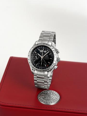 Omega Speedmaster Triple-Date.Omega, Speedmaster Automatic, No. 56419114, Ref. 3221.30.00. Made circa 2000..Fine, stainless steel, self-winding, water-resistant wristwatch with round button chronograph, 12-hour and 30-minute registers.24-hour indication, 