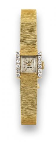 Omega Yellow Gold.Diamonds.Omega, movement No. 21051581, case.No. 7611112. Made in the 1960s..Fine and elegant, diamond-set 14K.yellow gold lady's wristwatch with an.Omega 14K yellow gold integral barkeffect.bracelet. Accompanied by an.Omega box..To be so