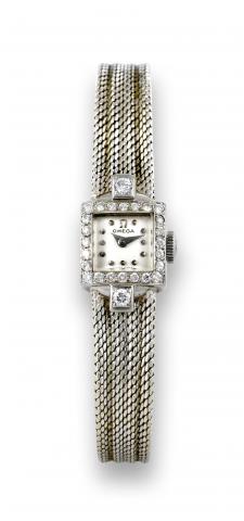Omega White Gold Diamonds.Omega, movement No. 12384537, case No. 10816168..Made in the 1950s..Fine and elegant, diamond-set 18K white gold lady's.wristwatch with an 18K white gold integral bracelet..To be sold without reserve