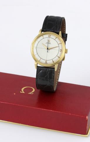 Omega Ref. 2643.Omega, Automatic, movement No. 12519210, case.No. 11044420, Ref. 2643. Made circa 1952..Fine, self-winding, center seconds, 18K yellow gold.wristwatch with honeycomb dial and a gold-plated Omega.buckle. Accompanied by an Omega box..To be s