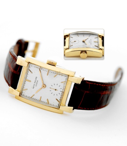 Patek Philippe Ref. 2427 Yellow Gold.Patek Philippe Cie, Geneve, No. 973571, case No. 512699, Ref. 2427. Made circa.1951..Fine and rare, large, rectangular curved, 18K yellow gold wristwatch with an.18K yellow gold Patek Philippe buckle.