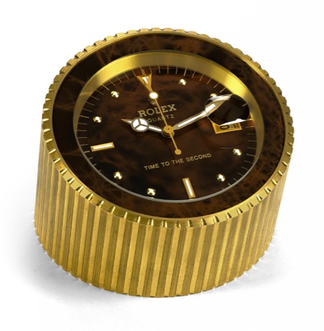 ROLEX TIME TO THE SECOND.Rolex, Quartz, Time to the Second.Ref. 8035, 1980's..Fine and unusual center-second, gilt brass table.clock with date. Produced in limited series for.presentation to Rolex Retailers.