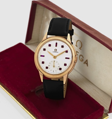 omega - pink gold Ruby Dial.Omega, Ref. 14173, No. 11317808. Made circa 1945..Very fine, rare and elegant, 18K pink gold wristwatch with.ruby-set dial and gold-plated Omega buckle. Accompanied.by a period Omega box.