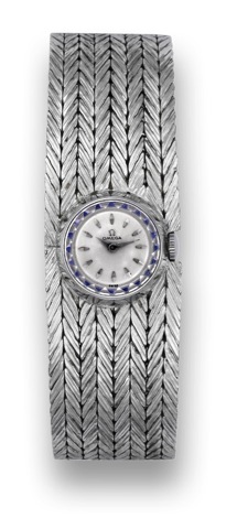 Omega, movement No. 16777772, case No. 448912, Ref. 10915..Made circa 1960..Fine and elegant, circular, 18K white gold wristwatch with an associated 18K.white gold integrated textured bracelet..To be sold without reserve