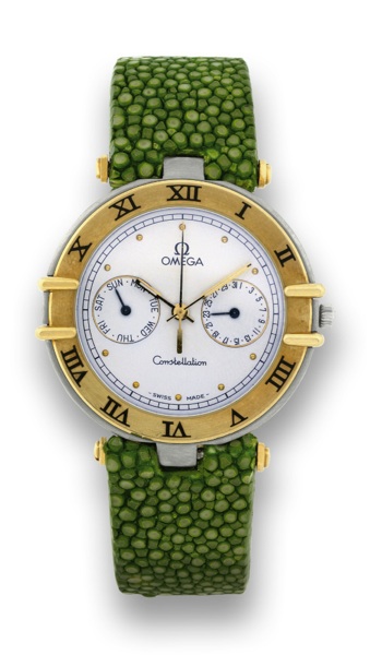 OMEGA CONSTELLATION DAY DATE.Omega, Constellation, Ref. CH 50.167.853. Sold on April.9th, 1988..Fine, center-seconds, stainless steel and 18K yellow gold.quartz wristwatch with registers, and gold plated Omega.butterfly deployant clasp. Accompanied by Ome