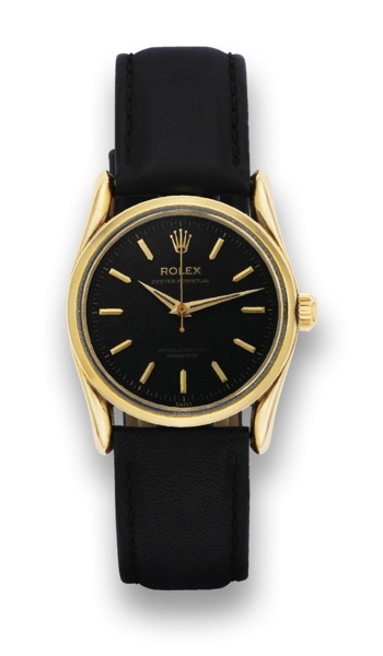 ROLEX REF. 6590, BOMBAY.Rolex, Oyster Perpetual, Officially Certified Chronometer.case No. 8881**. Made in 1952..Fine and rare, center-seconds, self-winding, water-resistant.14K yellow gold wristwatch with black honeycomb dial.