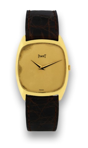 PIAGET YELLOW GOLD -.Piaget, movement No. 751511, case 258700, Ref. 9591. Made in the 1960's..Fine, tonneau shaped, 18K yellow gold wristwatch with a yellow gold Piaget buckle.