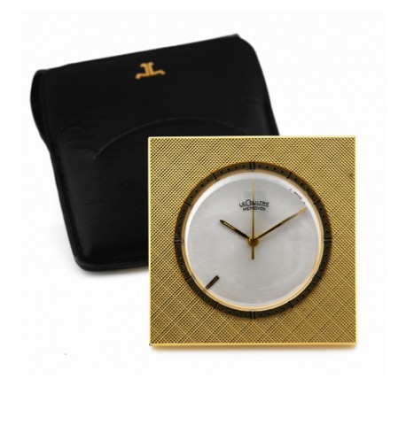 LECOULTRE MEMOVOX TRAVEL ALARM CLOCK.LeCoultre, Memovox. Made in the 1960's..Fine, gilt-brass and Perspex, 8-day going desk clock.with alarm..To be sold without reserve