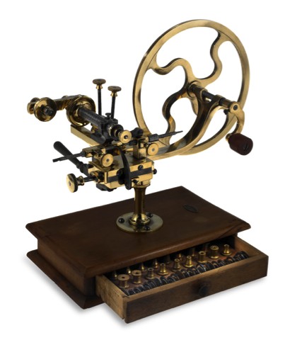 ROUNDING-UP TOOL.Sandoz Fils Co., La Chaux-de-Fonds Bienne, Swiss. Made.circa 1910..Fine, brass and steel rounding-up tool on wooden base with.drawer containing a selection of cutting wheels..To be sold without reserve
