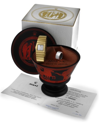 ROLEX REF. 3580J, KING MIDAS _ WITH ORIGINAL BOX AND PAPERS.Rolex, No. 949, case No. 3434021, Ref. 3580J. Sold on June 17, 1974..Fine and elegant, asymmetrical, left-handed, heavy 18K yellow gold wristwatch with an integral 18K yellow gold Rolex link brac