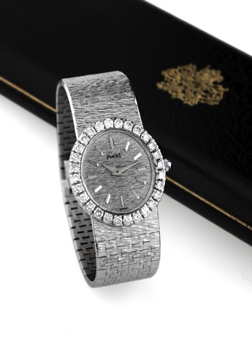 PIAGET REF. 9814 WHITE GOLD DIAMONDS.Piaget, case No. 297886, Ref. 9814 A6. Made in the 1990s..Very fine and elegant, 18K white gold and diamond-set.wristwatch with an integral 18K white gold textured Piaget.bracelet. Accompanied by a Piaget fitted box.
