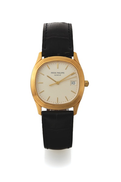 PATEK PHILIPPE REF. 3701.QUARTZ YELLOW GOLD.Patek Philippe, Genève, No. 1550186, case No. 2810268.Ref. 3701. Made in the late 1980s..Fine, cushion-shaped, center seconds, 18K yellow gold.quartz wristwatch with date and an integral 18K yellow.go