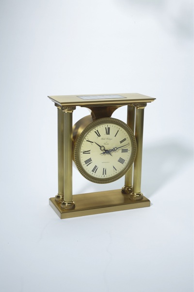 PATEK PHILIPPE REF. 1504 SOLAR EMPIRE STYLE CLOCK RETAILED BY TIFFANY CO BRASS.Patek Philippe, Genève, No. 873897. Made circa 1965..Fine and rare, gilt brass, solar-powered Empire-style mantel clock with electrically-wound remontoir.
