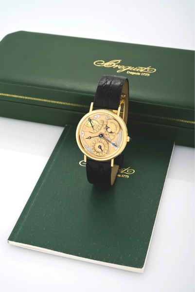 BREGUET REF. 3135 YELLOW GOLD SEMI-SKELETONIZED.Breguet, No. 5066, movement No. 5890, Ref. 3135. Sold on.February 15th, 1994..Very fine and very rare, self-winding, 18K yellow gold.wristwatch with power-reserve, date, phases and age of.the moon