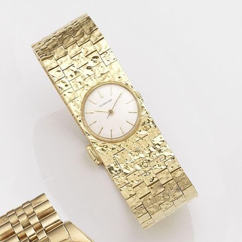 Swiss. A lady's 18k gold manual wind bracelet watch