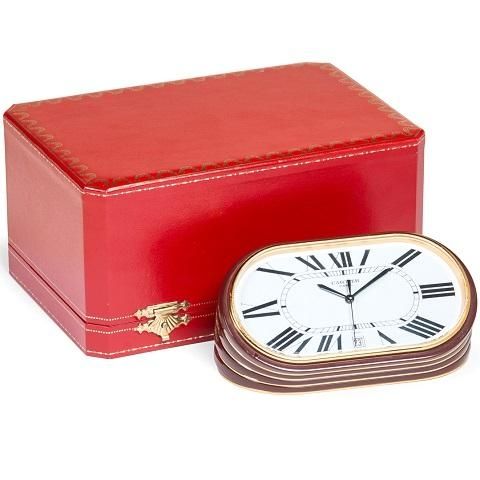 Cartier. A gilt metal quartz calendar desk clock with box
