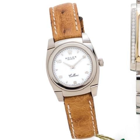 Rolex. A lady's 18K white gold manual wind wristwatch with paper