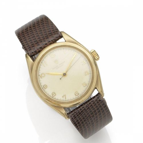 Rolex. A 9K gold manual wind wristwatch