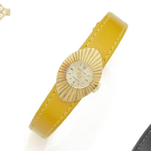 Rolex. A lady's 18K gold manual wind wristwatch
