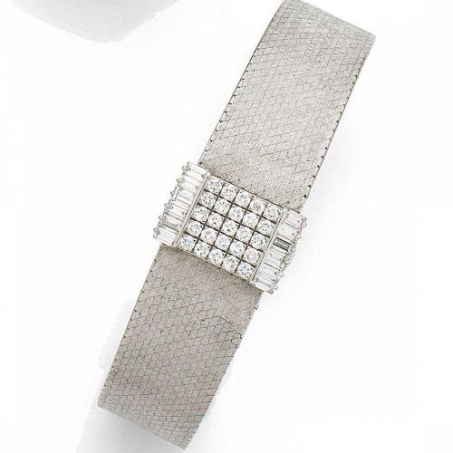 Patek Philippe. A lady's 18K white gold and diamond set manual wind bracelet watch with concealed dial
