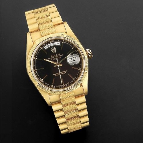 Rolex. An 18K gold automatic calendar bracelet watch