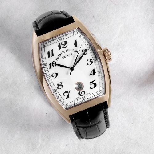 Franck Muller. An 18K gold tonneau automatic calendar wristwatch