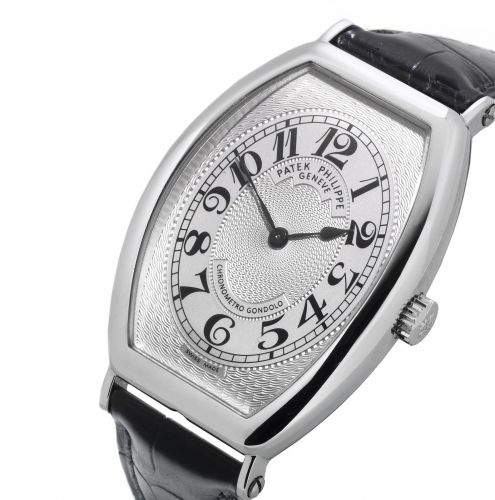Patek Philippe. A platinum tonneau manual wind wristwatch