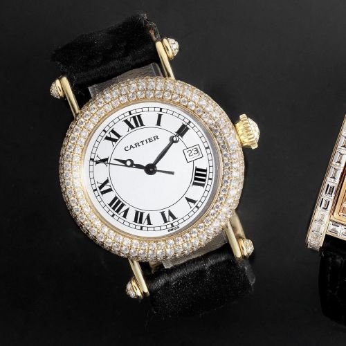 Cartier. An 18K gold and diamond set quartz calendar wristwatch