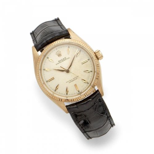 Rolex. An 18K gold automatic wristwatch