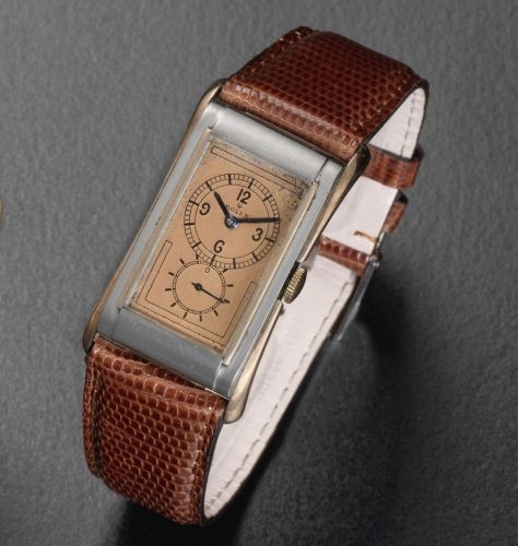 Rolex. A stainless steel and rose gold manual wind rectangular wristwatch