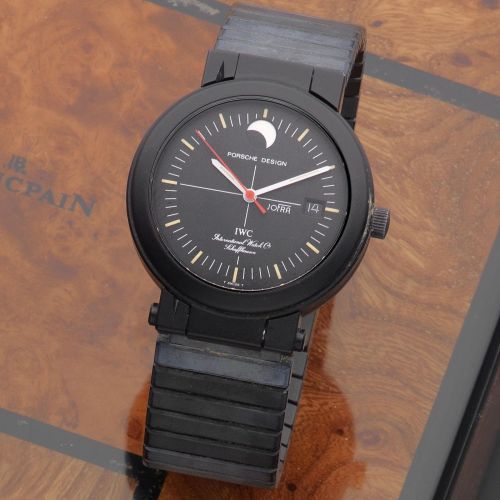 IWC with Porsche Design. A black DLC coated aluminium automatic calendar bracelet watch with moon phase and concealed compass
