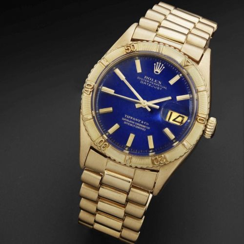 Rolex. An 18K gold automatic calendar bracelet watch retailed by Tiffany Co