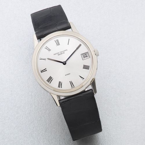 Patek Philippe. An 18K white gold automatic calendar wristwatch