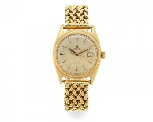 Rolex. An 18K gold automatic calendar bracelet watch