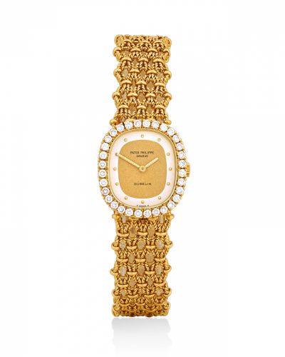 Patek Philippe. A lady's 18k gold and diamonds manual wind oval wristwatch with bracelet