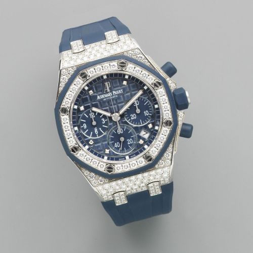Audemars Piguet. A fine mid-size 18K white gold and diamond set automatic calendar chronograph wristwatch