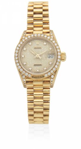 Rolex. A lady's 18K gold diamond set automatic calendar bracelet watch