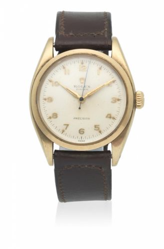 Rolex. A 9K gold manual wind wristwatch