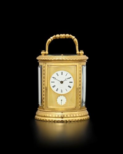 A gilt brass oval bell-striking and repeating carriage clock with alarm
