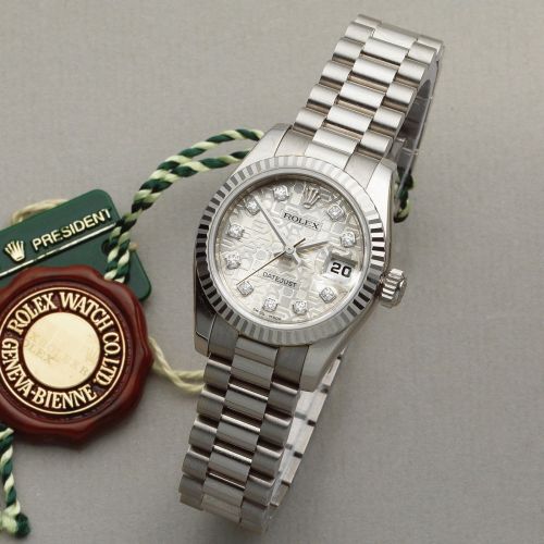Rolex. A lady's 18K white gold diamond set automatic calendar bracelet watch