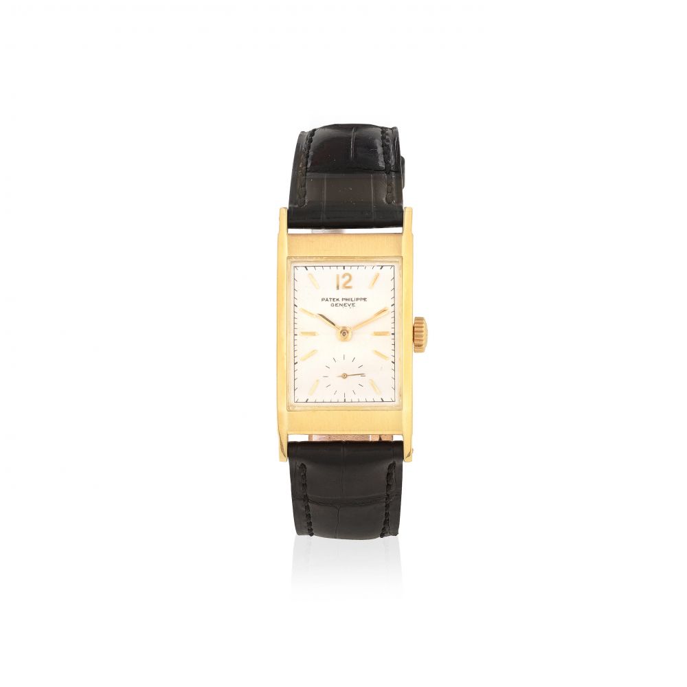 Patek Philippe. An 18K gold manual wind rectangular wristwatch with faceted glass