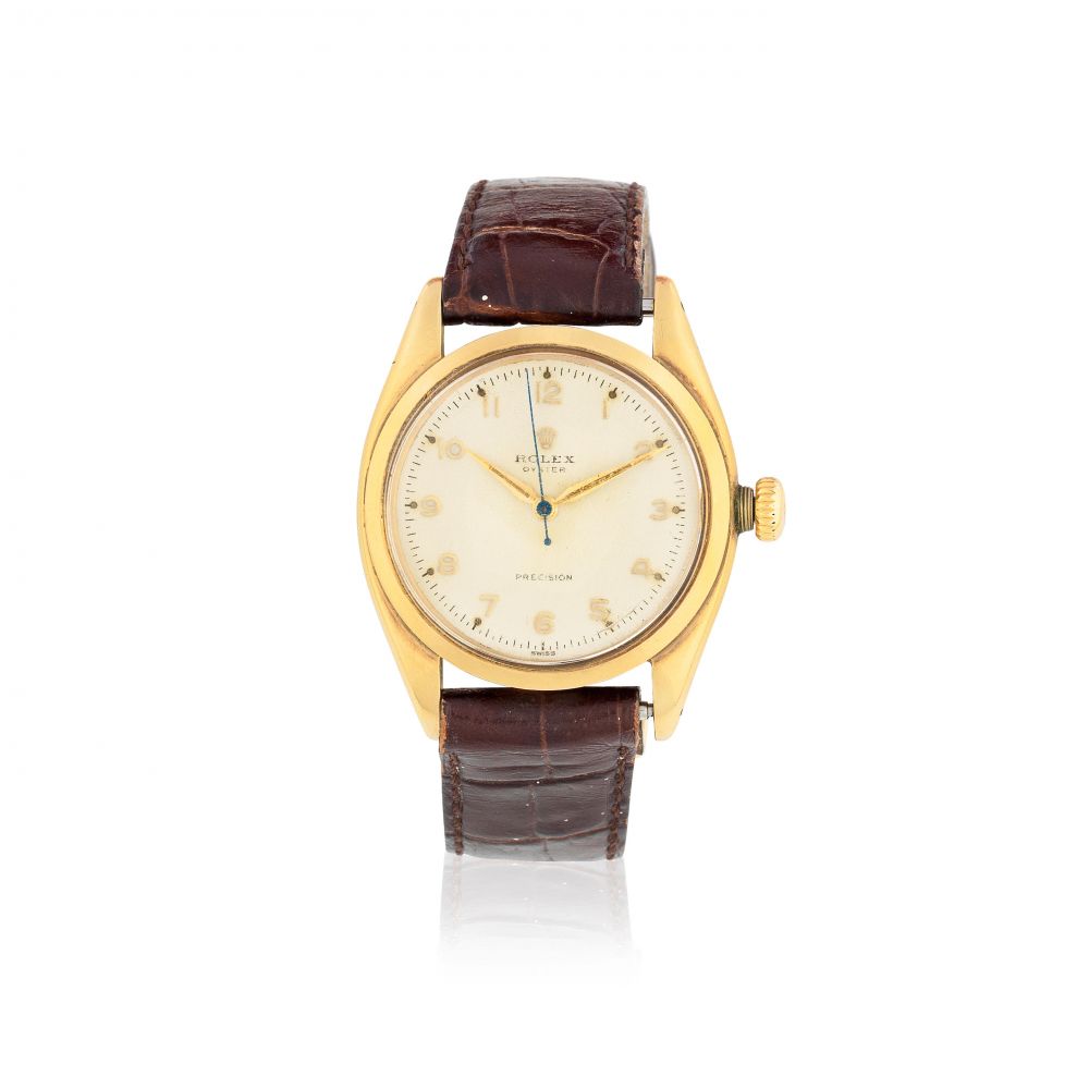 Rolex. A 9K gold manual wind wristwatch