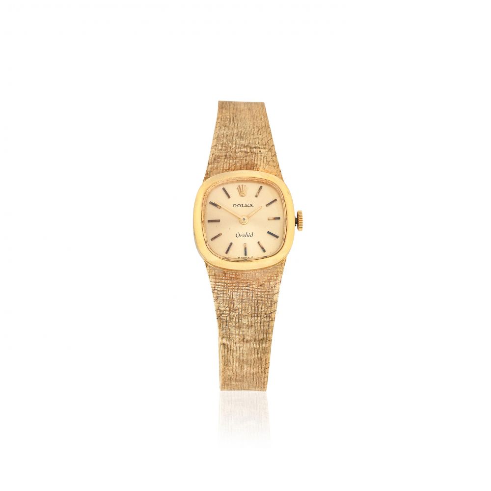 Rolex. A lady's 18K gold manual wind bracelet watch