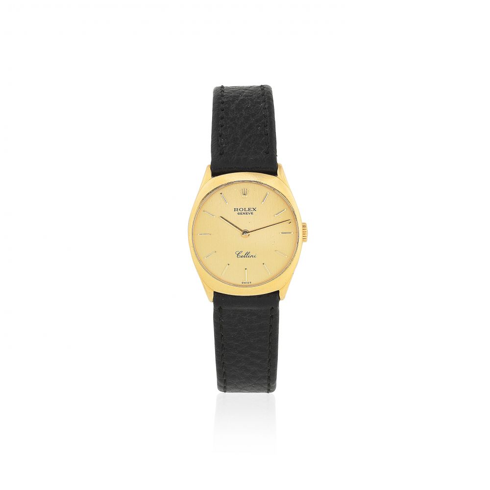 Rolex. A lady's 18K gold manual wind tonneau form wristwatch