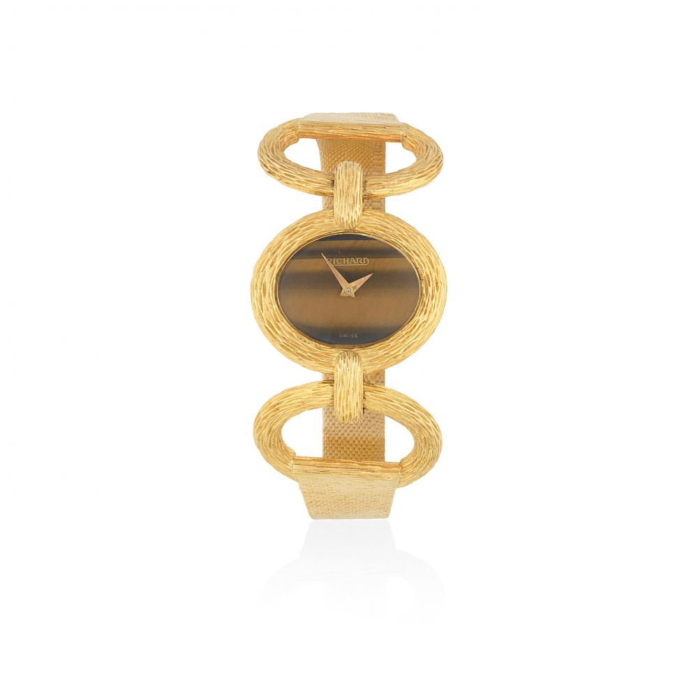 Richard. A lady's 18K gold manual wind oval bracelet watch with tiger's eye dial